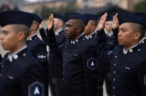 Military service members in uniform saluting